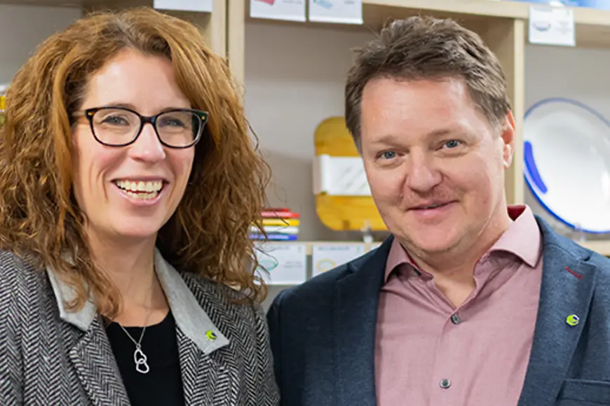 Eine Frau und ein Mann stehen nebeneinander und schauen in die Kamera